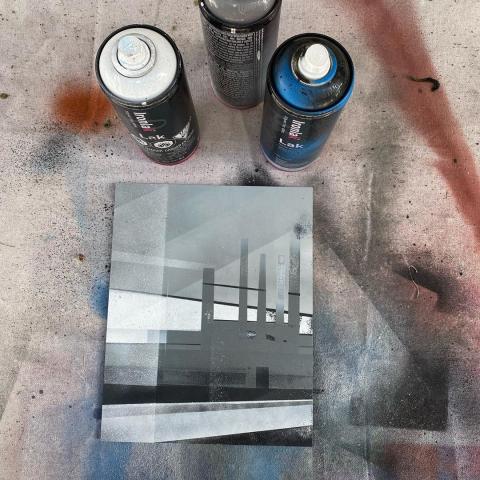 Spray paint on board painting of a factory