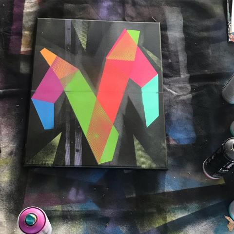 Spray paint painting of the letter M