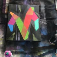 Spray paint painting of the letter M